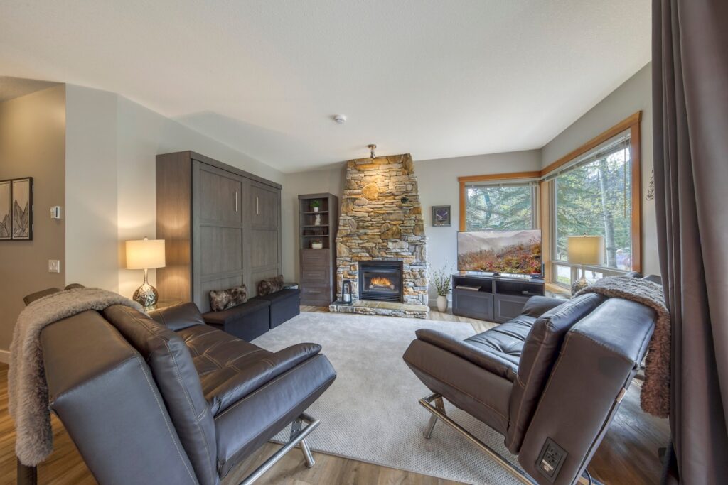 166ab346-6032-4f01-bed3-64e3b94b08b7 Spacious living room with ample natural lighting. Beautiful Queen Murphy bed transforms the living room into a 3rd bedroom.